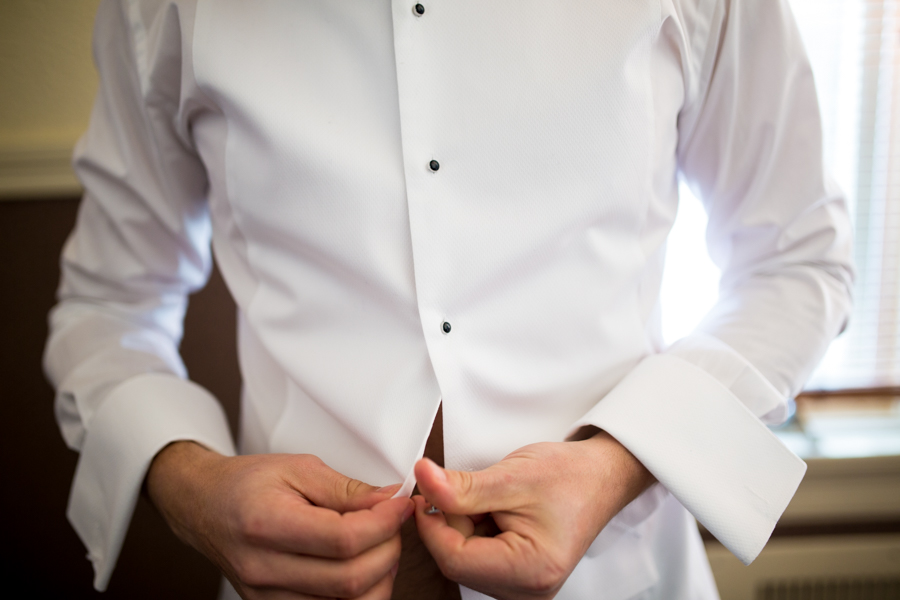 groom doing up buttons