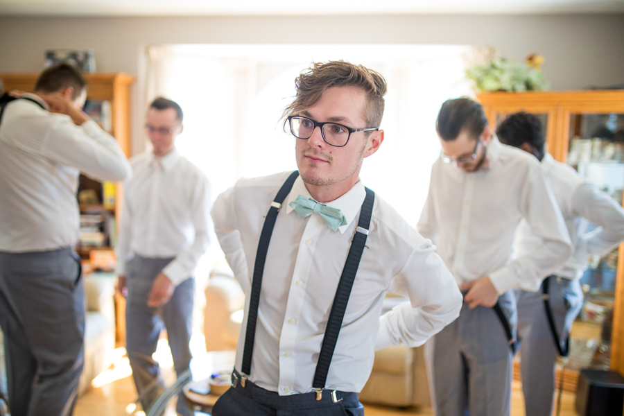 groom wearing suspenders, groom getting ready 