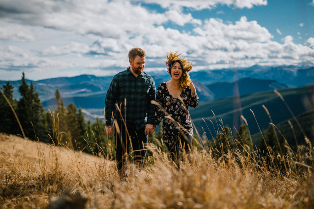 puppy, bragg creek, river, engagement, bragg creek engagement, love in the mountains, rockies engagement, windy, dirty boots messy hair, kiss