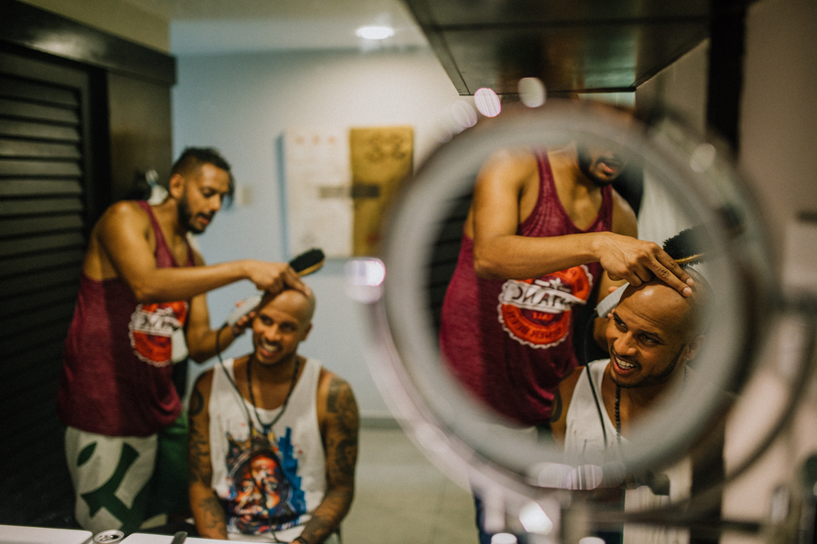 groom getting his hair done for the wedding