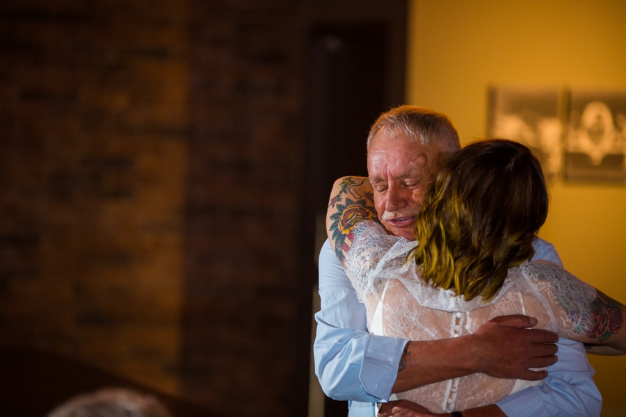 bride hugging her grandfather in the Baron event venue