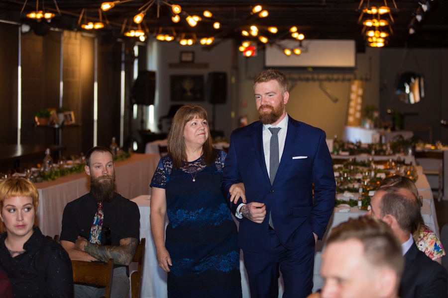 groom being walked down the aisle by his mother at The Baron, Calgary