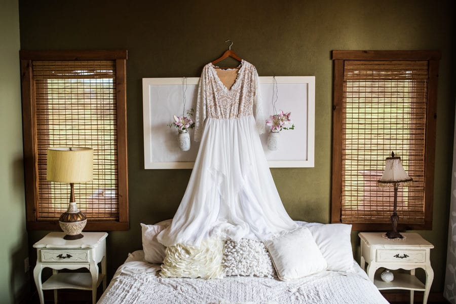 hanging up the dress in the cottage at woodland and wildflower wedding venue