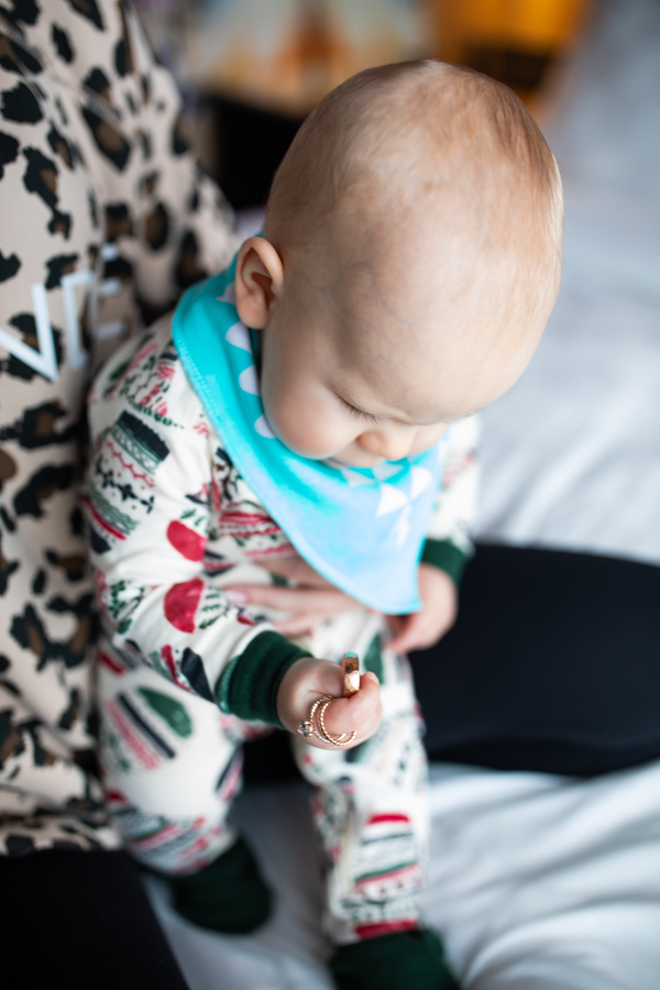 baby holding wedding rings for mom and dad