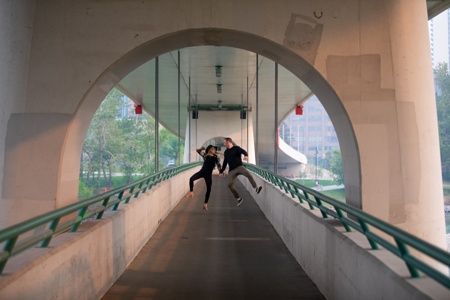 couple playing on a bride during engagement session