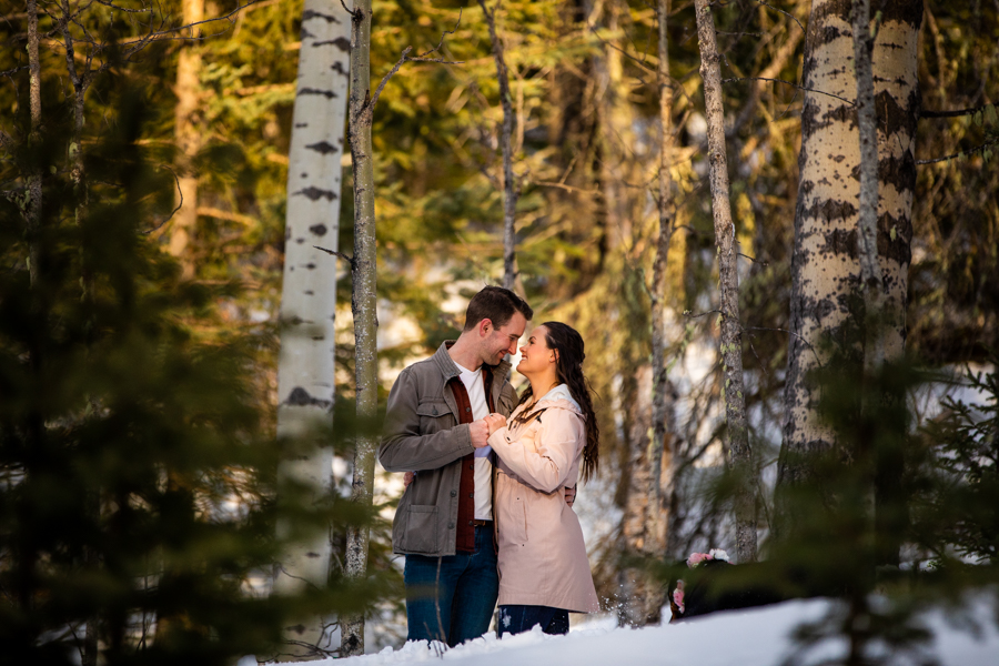 couple standing in the wood while social distancing