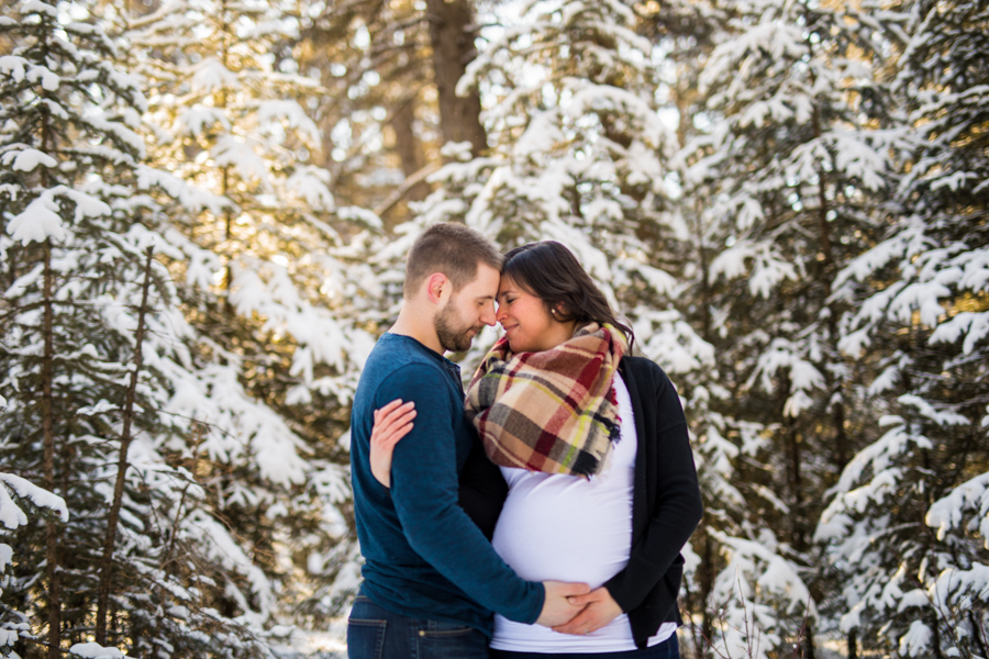 couple in the snow maternity session