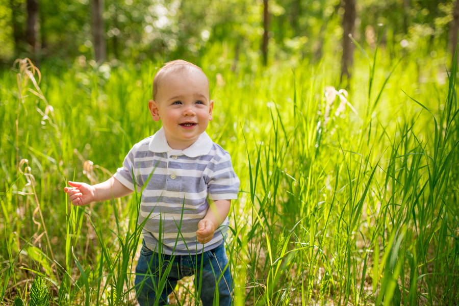 baby walking through the grass in Calgary park