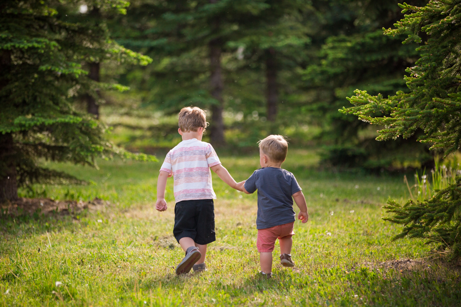 two boy walking int the field