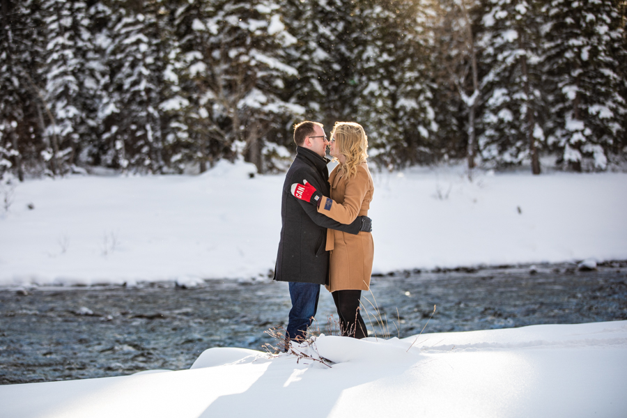 Couple in the snow getting pictures taken