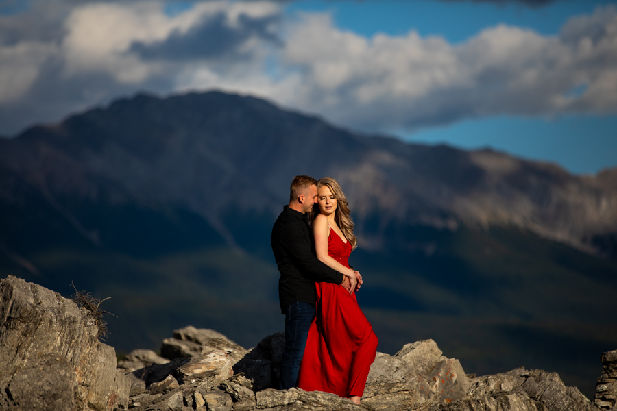 couple on a peak her in a red dress
