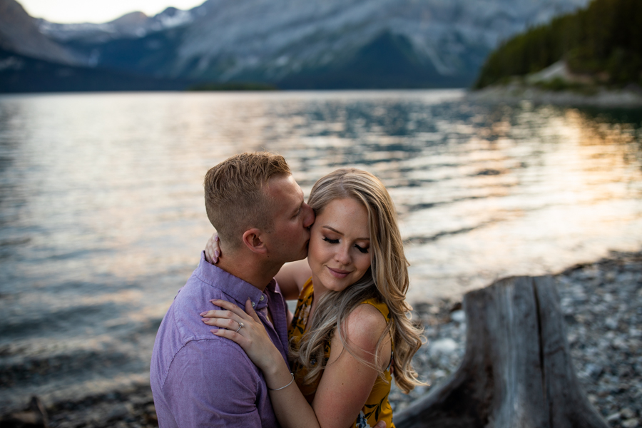 sunset on a lake with a couple kissing