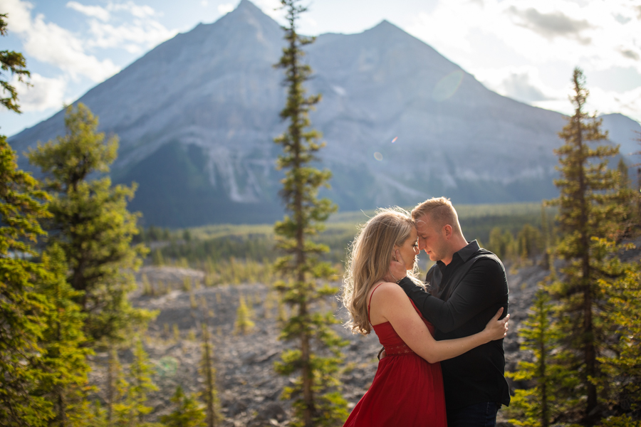 girl in a red dress kissing boyfirend