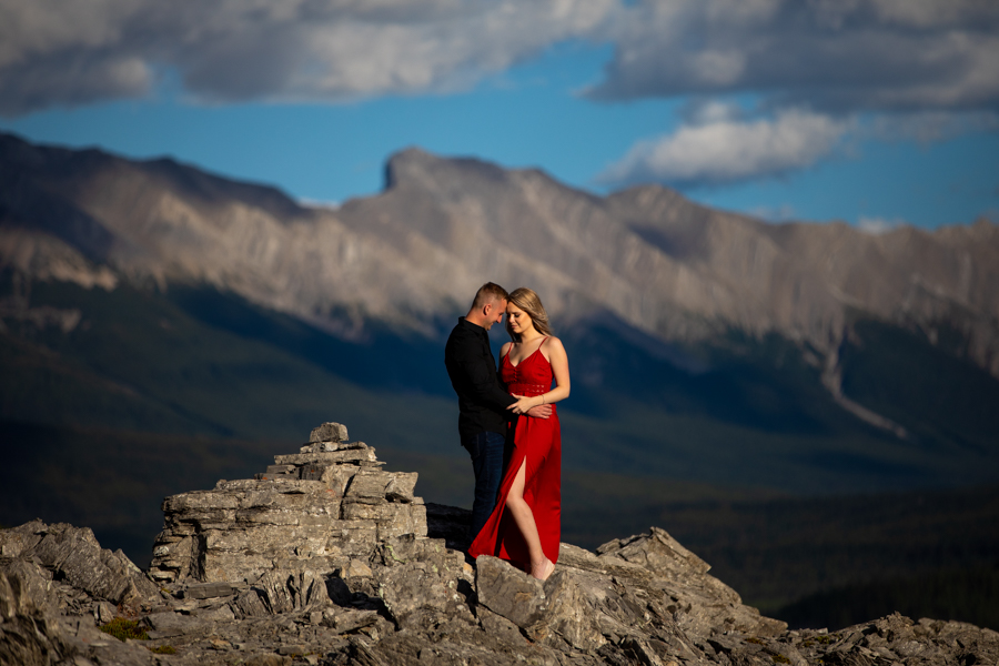 couple kissing on a peak