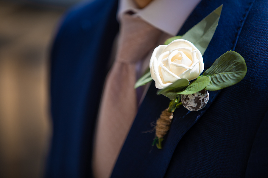 flowers on the grooms lapel