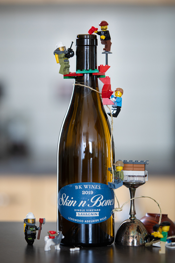 lego men climbing a wine bottle