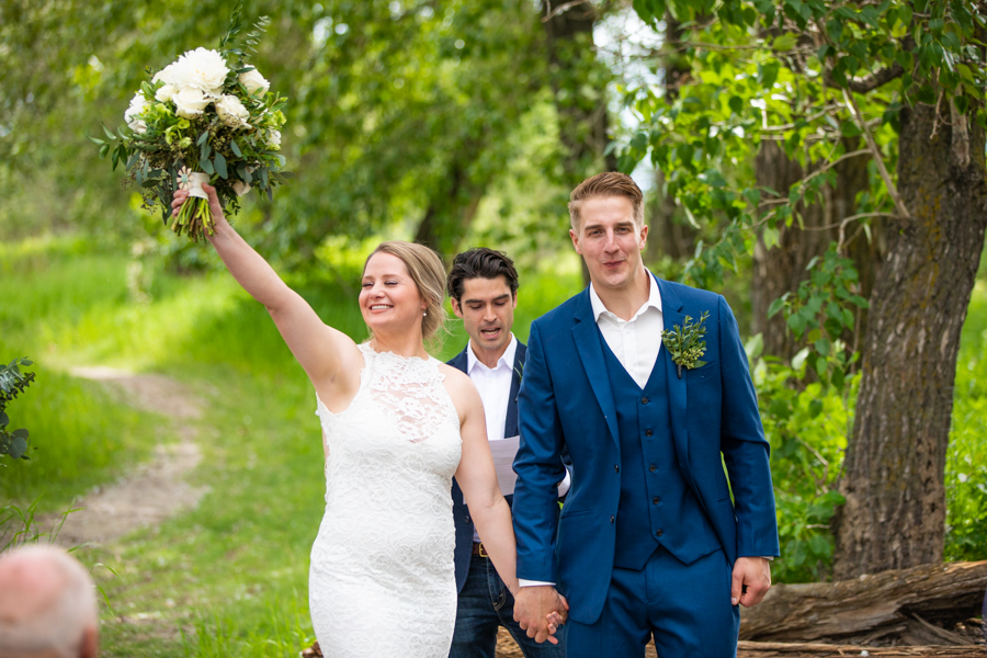 bride and groom cheer after first kiss