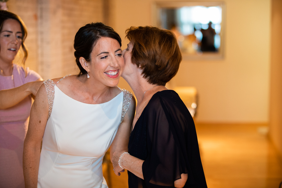 mom kissing daughter in rooftop elopement in edmonton