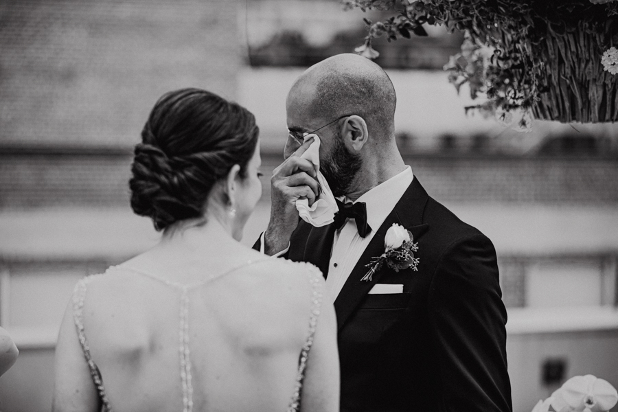 groom crying on a rooftop elopement in edmonton