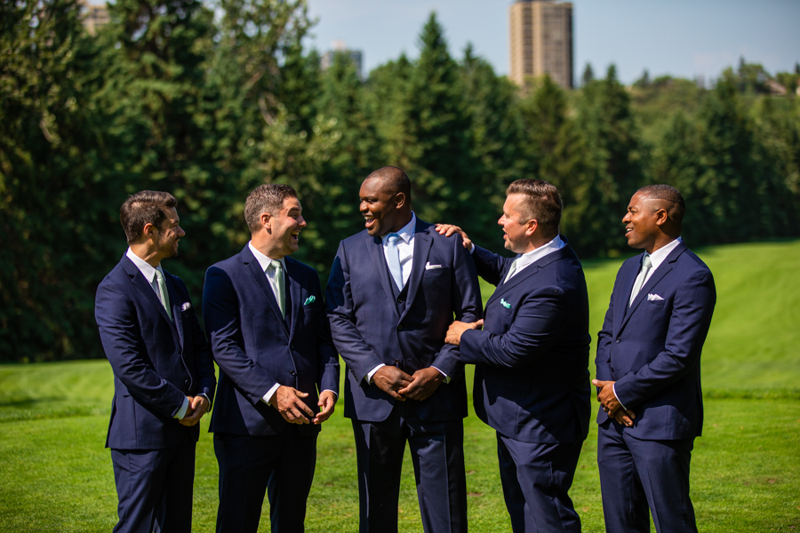 groom and groomsmen standing on the golf course