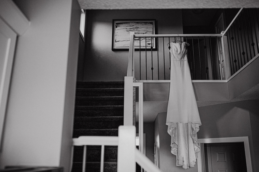wedding dress hanging on a stairweel
