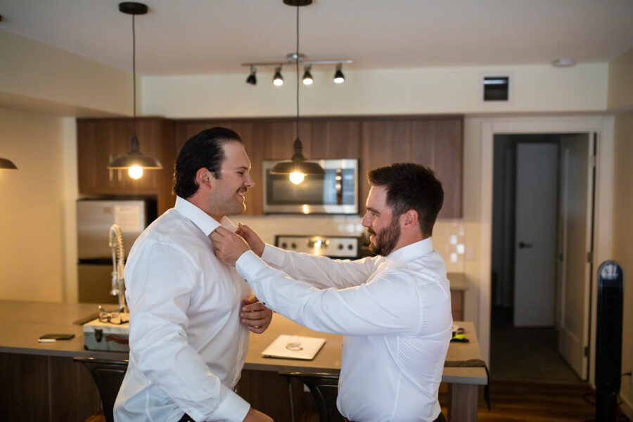 groom and best man getting ready in Canmore