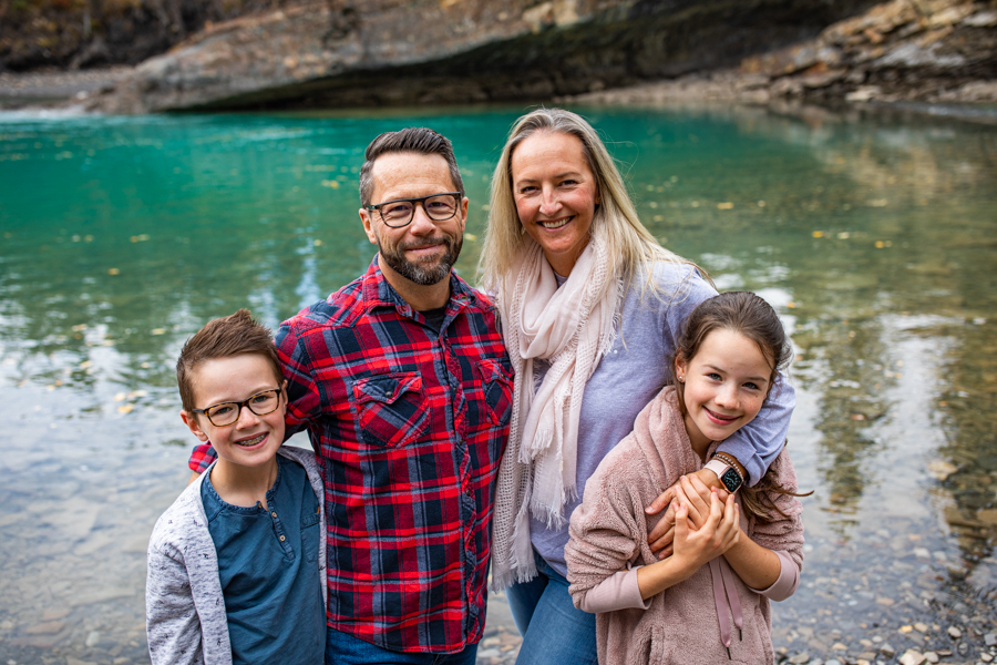 family of four standing for a family portrait