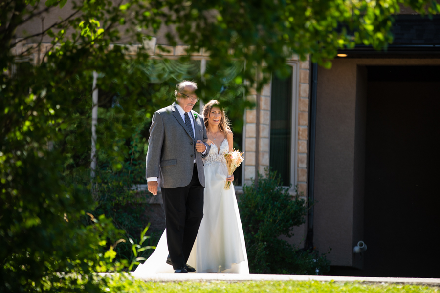 dad walking down the aisle at bearspaw house