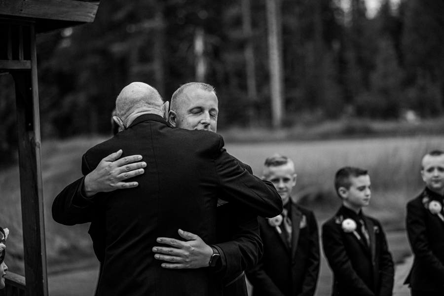 Groom hugging father at Canmore