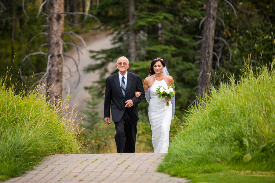 Bride coming down the aisle of Silvertip golf course wedding venue