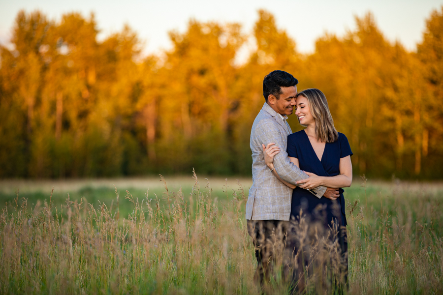 couple in a field for sunset photos