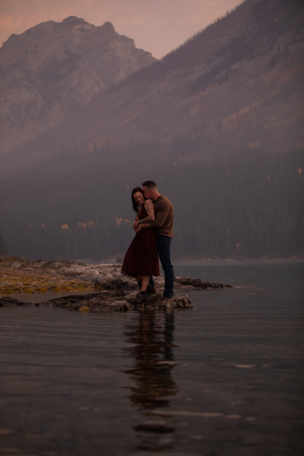 couple cuddling in the sunrise