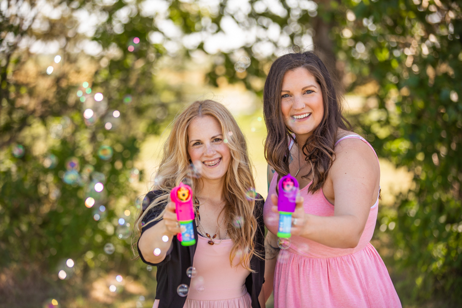 sisters playing with bubbles