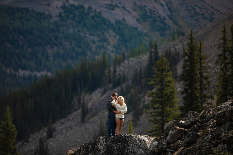 couple standing on a rock at Moraine Lake