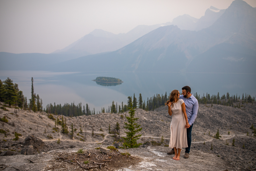 couple cuddling by a lake